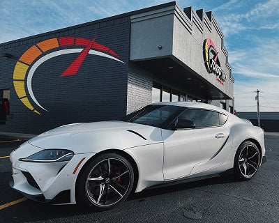 White car with Turbo tint Automotive window tint in front of building logo